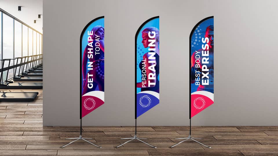 Promotional feather banners with fitness graphics installed with cross bases