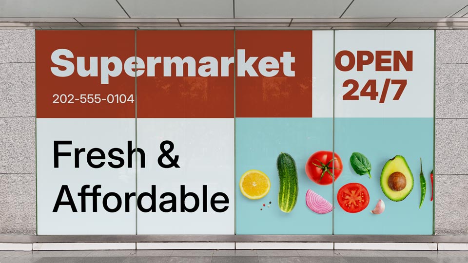 Informative store window decals for a supermarket featuring contact info and a slogan