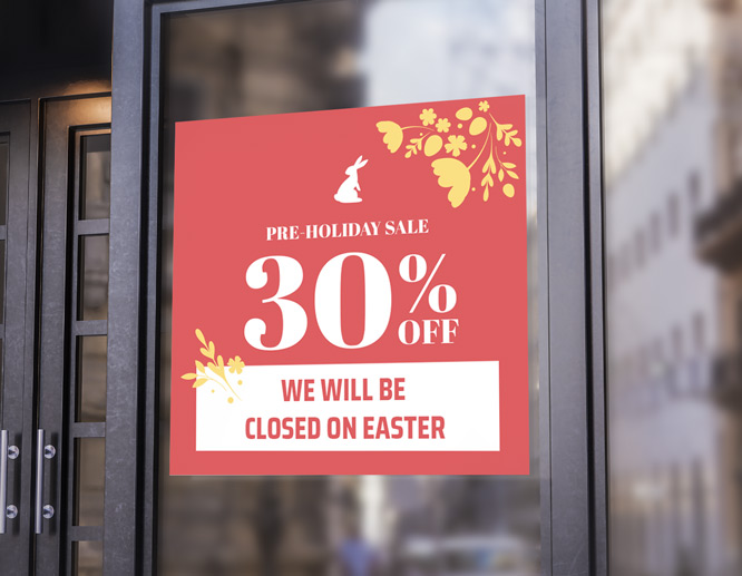 Promotional closed for Easter sign in red reading a pre-holiday sale on the storefront window