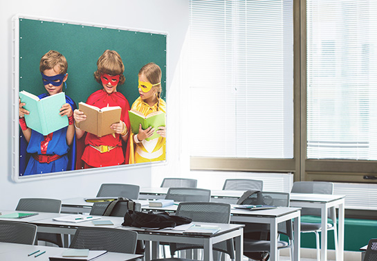 cute school banner displaying little superheroes reading a book