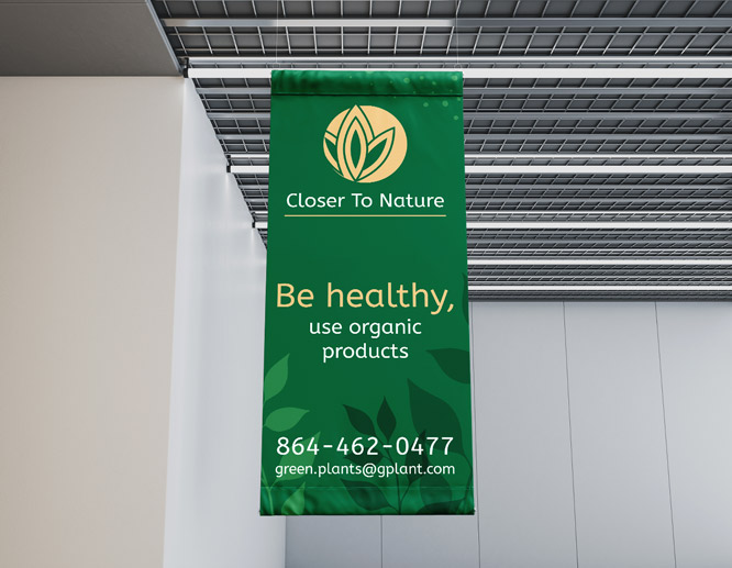 Green sustainable fabric banner promoting organic products hanging from a ceiling.
