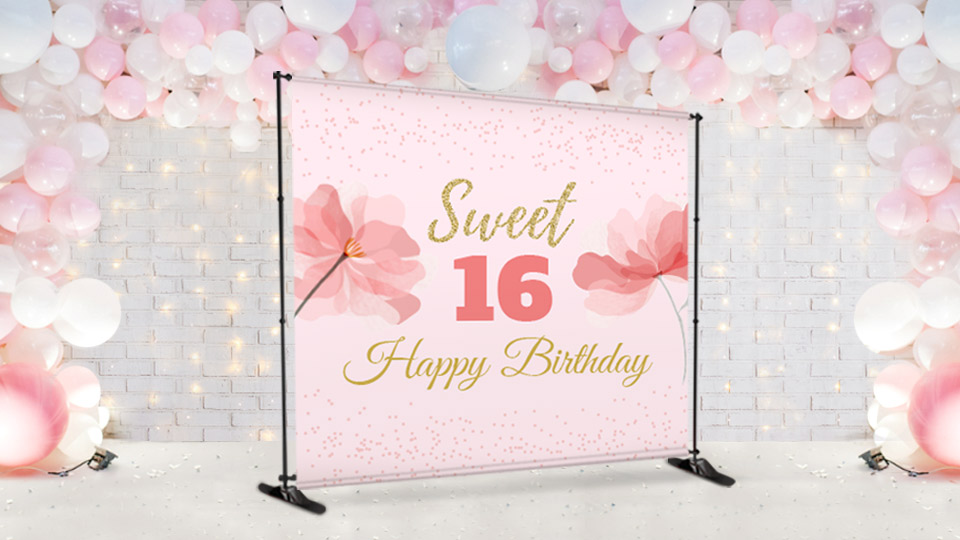A Sweet 16 Happy Birthday backdrop with floral design in light pink