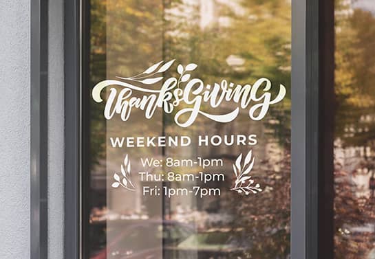 Thanksgiving business hours sign in white displayed on the door