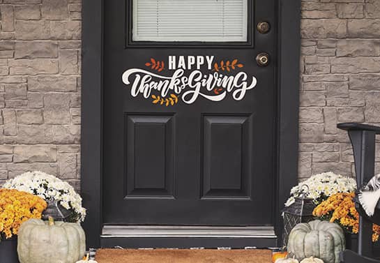 Happy Thanksgiving sign in white fixed to the front door