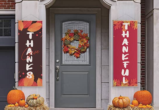 two colorful Thanksgiving welcoming banners at the front door