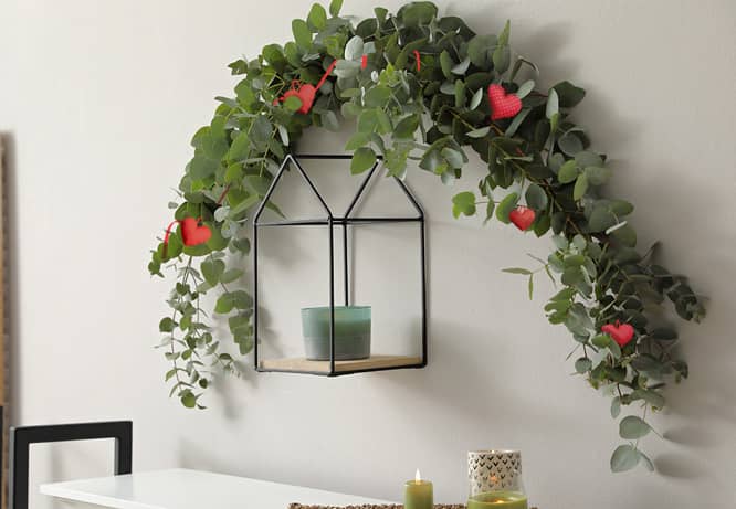 romantic room decoration idea with a garland made of leaves and heart shapes