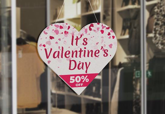 A heart-shaped Valentine’s Day sale sign for a storefront door decoration