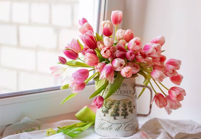 Vase of flowers near the window as a Valentine's day decoration idea