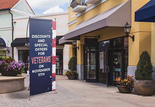 Veterans Day sale banner in blue displayed outdoors