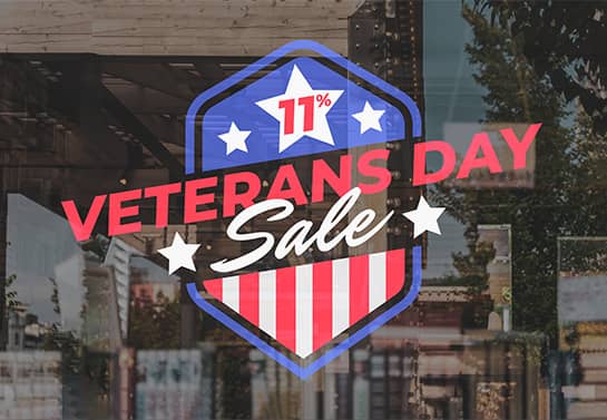 Veterans Day sale sign displaying a 11% discount on the window
