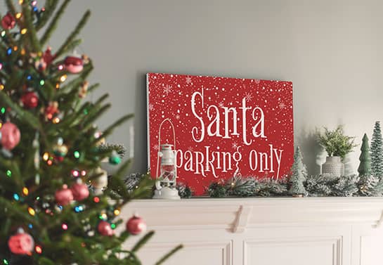 Mantel-mounted Christmas house sign displaying snowflakes