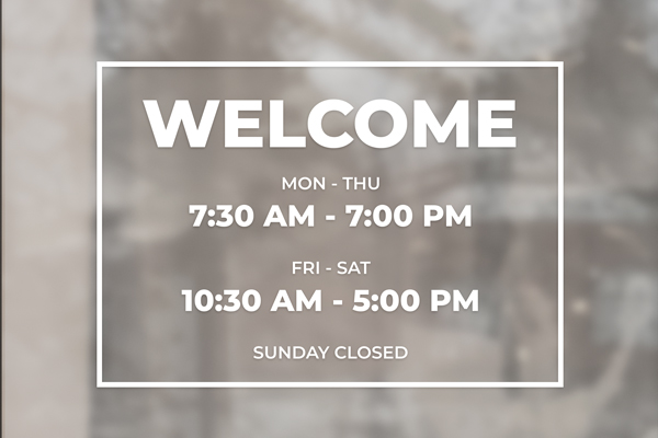 Welcoming vinyl lettering on the window featuring the business hours.