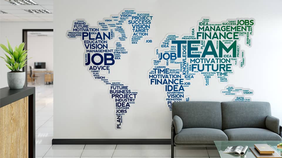 Wall decal applied to the office wall featuring corporate terms shaping the world map