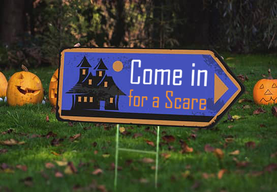 directional Halloween yard sign with a cute cartoon-themed display