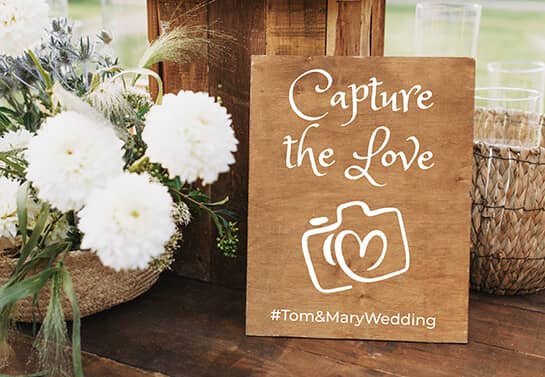 wooden wedding sign idea with a hashtag and camera icon”=