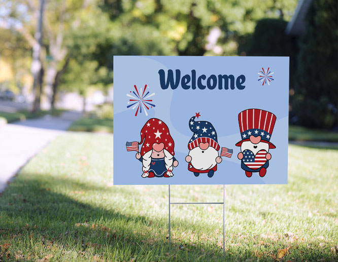4th of July yard sign showcasing gnomes and a Welcome quote installed near a house