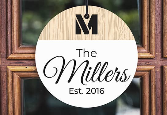 wood sign idea with the surname The Millers hung on the door