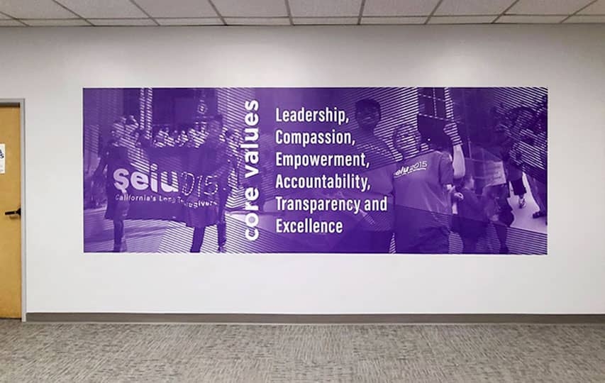 Purple office wall decal featuring a list of company's core values.
